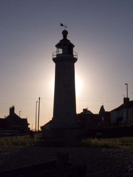 ENGLAND, West Sussex, Shoreham-by-Sea, Lighthouse silhouetted at sunset