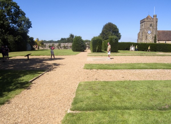 ENGLAND, East Sussex, Battle, Battle Abbey. Visitors in grounds of partially ruined abbey complex