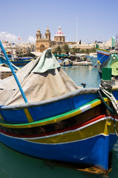 MALTA, Marsaxlokk , Fishing village harbour on the south coast with colourful Kajjiki fishing boats