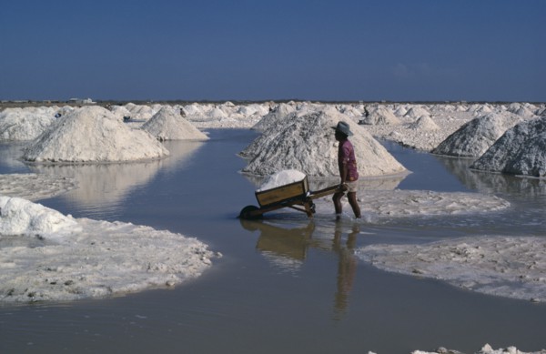 COLOMBIA, La Guajira , Manaure, Manaure Salt Mines in the Guajira Peninsula. A worker pushing a