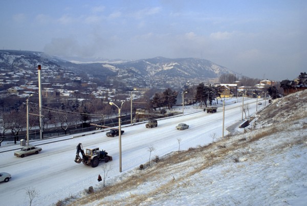 GEORGIA, Tbilisi, Cityscape and traffic in snow.