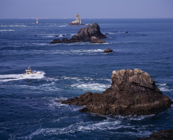 FRANCE, Brittany, Finistere, "Pointe du Raz.  Jagged outcrops of offshore rock protruding from sea