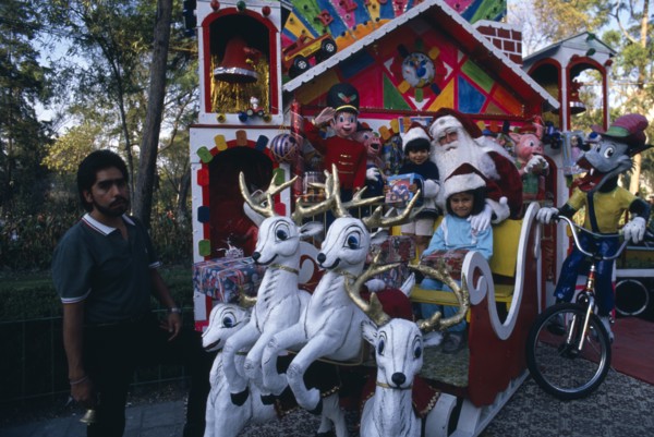 MEXICO, Mexico City, Children visiting Father Christmas in his sleigh in Mexico City Park