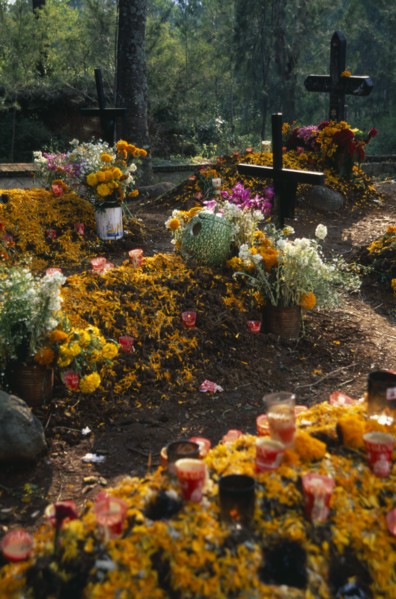 MEXICO, Michoacan, Patzcuaro, "Tzurumutaro Cemetery.  Graves decorated with candles, carved