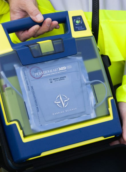 ENGLAND, West Sussex, Findon, Sheep Fair Ambulance service driver holding a mobile emergency