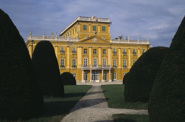 HUNGARY, Burgenland, Eisenstadt , Esterhazy Palace yellow painted exterior seen from formal gardens
