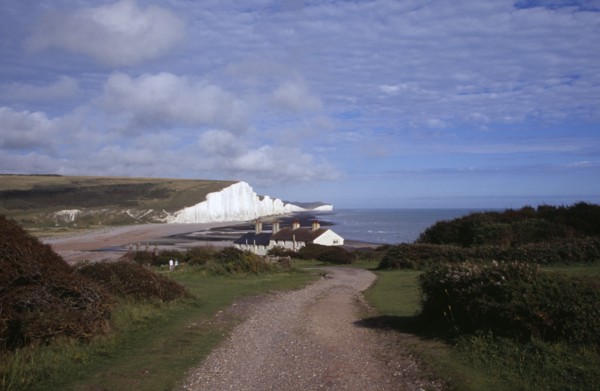ENGLAND, East Sussex, Seven Sisters, The Seven Sisters white chalk cliffs viewed from a path at