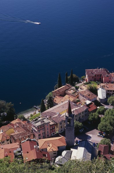 ITALY, Lombardy, Lake Como, "Varenna.  Looking down on red tiled rooftops, church and bell tower of