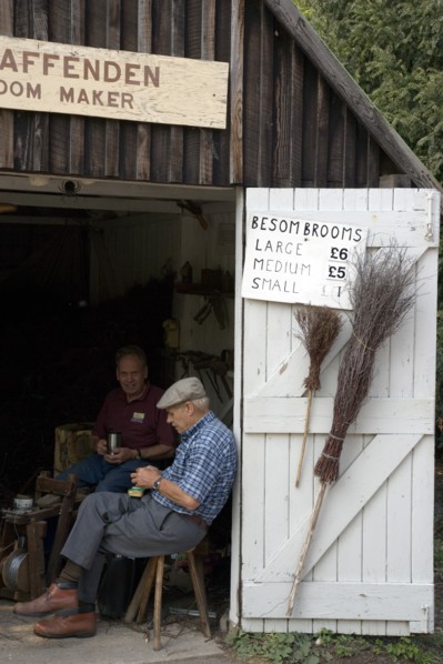 ENGLAND, West Sussex, Amberley, Amberley Working Museum. The Broom maker workshop with two men