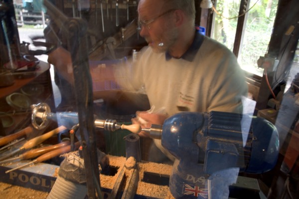ENGLAND, West Sussex, Amberley, Amberley Working Museum. The West Sussex Woodturners with a man