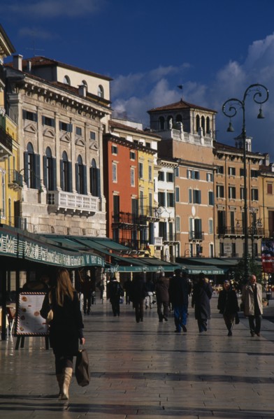 ITALY, Veneto, Verona, Piazza Bra.  People walking past line of bars and cafes and painted facades