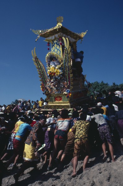 INDONESIA, Bali, Kuta, "Crowd carrying body of deceased to burning ground in highly decorated