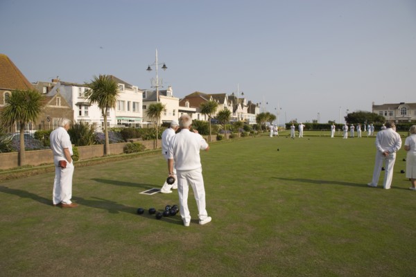 ENGLAND, West Sussex, Bognor Regis, Men playing a game of bowls on green