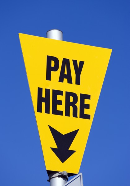ENGLAND, West Sussex, Littlehampton, Yellow car park sign against a blue sky with black writing