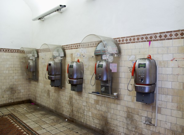 ITALY, Tuscany, Siena, Five public phone boxes in a tiled room