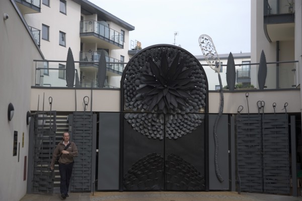 ENGLAND, East Sussex, Brighton, Ornate gates to new housing apartment development in West street.