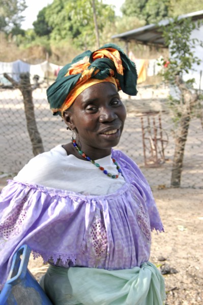 GAMBIA, Western Gambia, Tanji, Tanji village.  Three-quarter portrait of woman wearing traditional