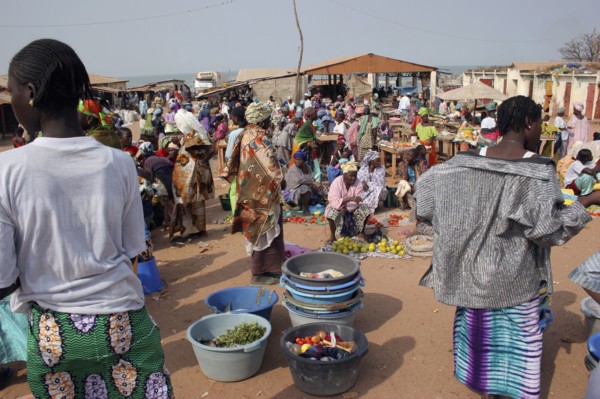 GAMBIA, Western Gambia, Tanji, Busy market scene with women selling fruit and vegetables and