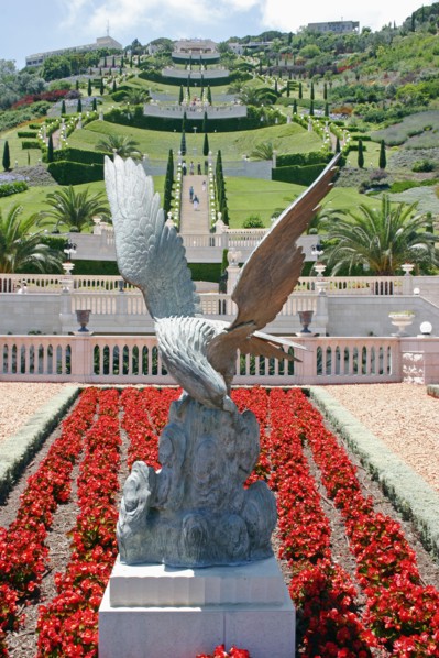 ISRAEL, Northern Coast, Haifa, Zionism Avenue.  Eagle sculpture set in flower bed of scarlet plants