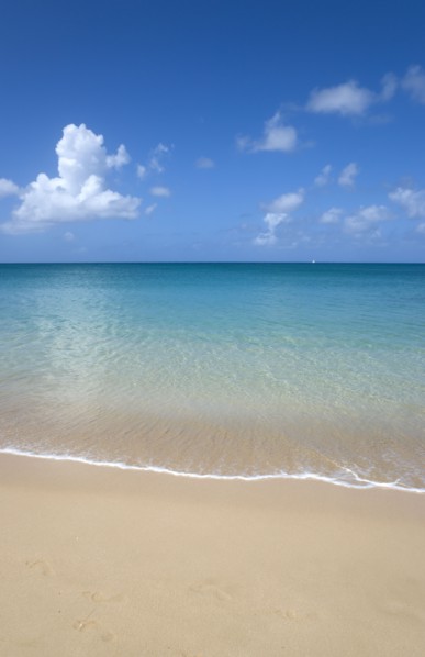 WEST INDIES, St Lucia, Gros Islet, View out to sea from Reduit Beach in Rodney Bay with a yacht
