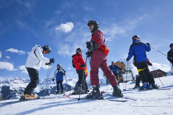 20091052 Group skiers about descend mountain. American Holidaymakers North America Tourism Tourist United States America  Dominant YellowDominant RedDominant BluePeople - GroupLeisure ActivitiesS...