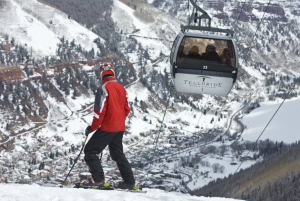 20091055 Skier slopes with cable car ski lift overhead passing by. Property Released American Automobile Automotive Cars Holidaymakers Motorcar North America Skiing Skis Tourism Tourist United States ...