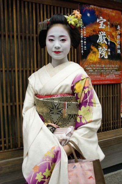 JAPAN, Honshu, Kyoto, "Gion District.  Three-quarter standing portrait of Geisha with white facial