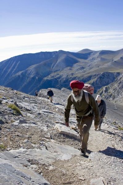 GREECE, Macedonia, Pieria, Olympus.  Group of four climbing steep slope of Mount  Olympus towards