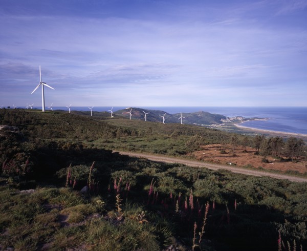 SPAIN, Galicia, Praia de Carnota, "Coastal landscape with line of wind powered electricity
