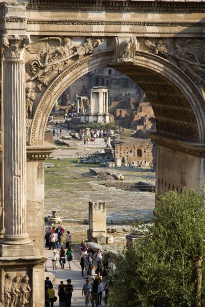 ITALY, Lazio, Rome, Tourists walking in the Forum with the Temple of The Vestals seen through the