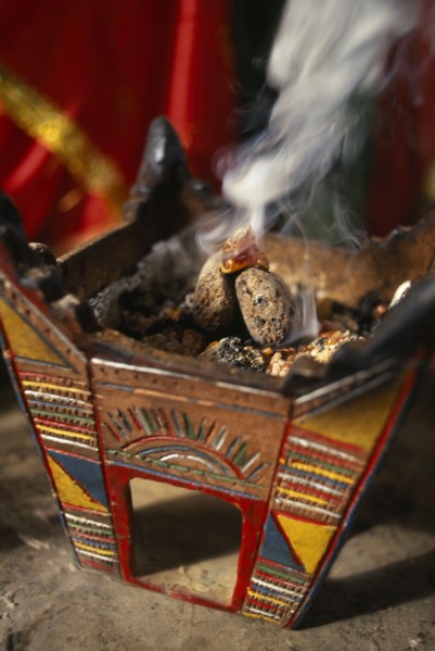 OMAN, Dhofar Hills, Beit Zarbij, Frankincense burning in tomb of the prophet Job. Near Salalah.