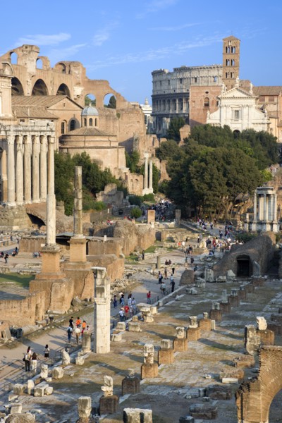 ITALY, Lazio, Rome, View of the Forum with the Colosseum rising behind the bell tower of the church