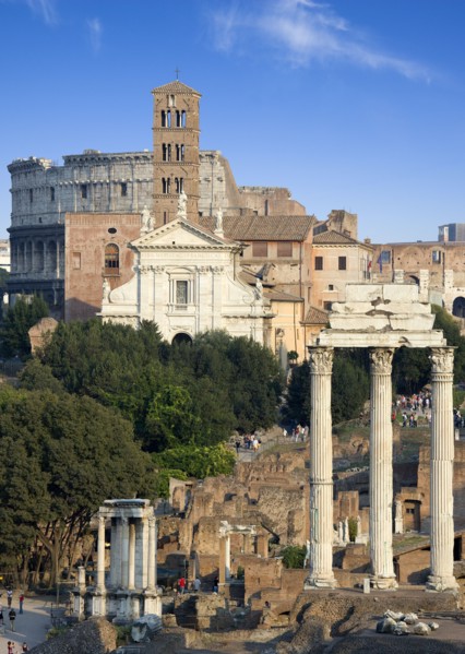 ITALY, Lazio, Rome, View of the Forum with the Colosseum rising behind the bell tower of the church