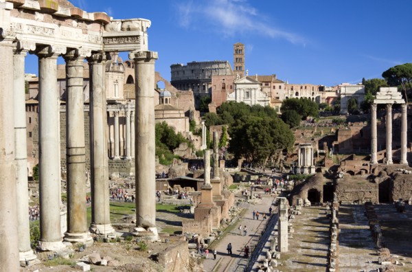 ITALY, Lazio, Rome, The Forum with the Colosseum rising behind the bell tower of Santa Francesca
