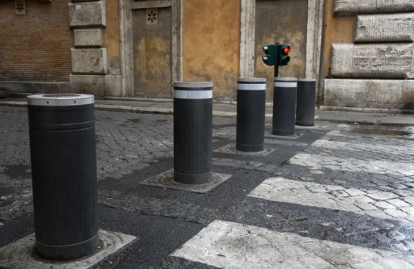 ITALY, Lazio, Rome, Automatic rising bollards and a pedestrian crossing in a side street with red