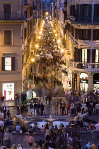 ITALY, Lazio, Rome, The Via dei Condotti the main shopping street busy with people illuminated at