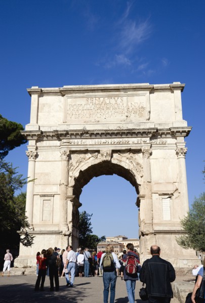 ITALY, Lazio, Rome, Tourists around the 19th Century reconstruction of the triumphal Arch of Titus