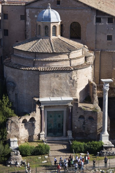 ITALY, Lazio, Rome, Tourists in the Forum outside the 4th Century Temple of Romulus which survived