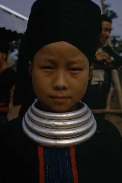 LAOS, Tribal People, Meo Tribe, Head and shoulders portrait of a Meo girl wearing traditional dress