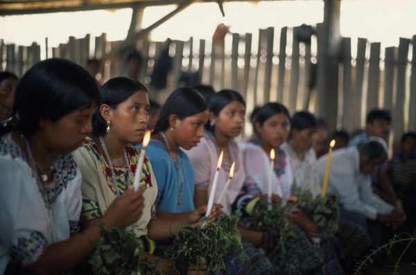 GUATEMALA, Alta Verapaz, Religion, Q’eqchi Indian girls holding candles at Roman Catholic Mass