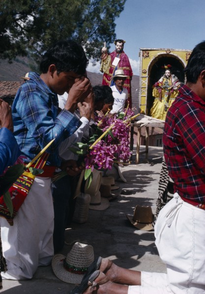 GUATEMALA, El Quiche, San Andres de Sajcabaja, Quiche Indian men knelling in prayer to the saints