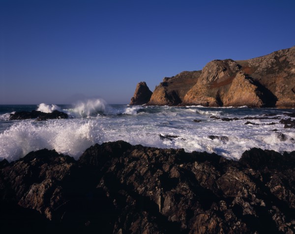 UNITED KINGDOM, Channel Islands, Jersey, St Ouen. Le Pulec. Rough sea and waves crashing against