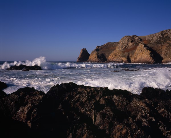 UNITED KINGDOM, Channel Islands, Jersey, St Ouen. Le Pulec. Rough sea with waves crashing against