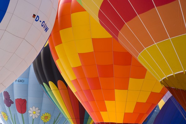 SWITZERLAND, Canton de Vaud, Chateau d'Oex, Inflated Hot Air Balloons with prominent flower pattern