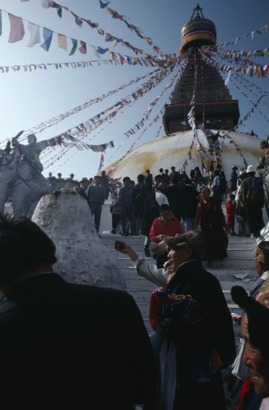 NEPAL, Kathmandu, Bodhanath, Crowd of Tibetans offering incense on the steps of the main stupa