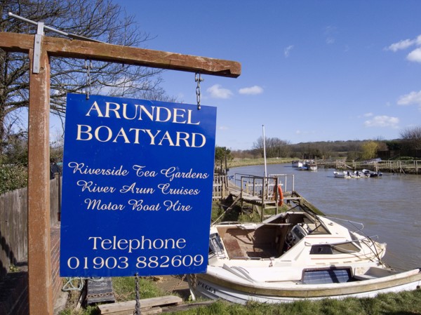 ENGLAND, West Sussex, Arundel, Sign for boatyard on the riverbank.