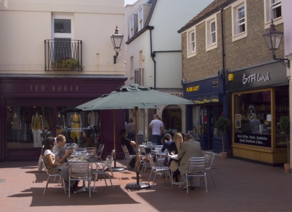 ENGLAND, East Sussex, Brighton, People sat at tables outside cafe in Dukes Lane.