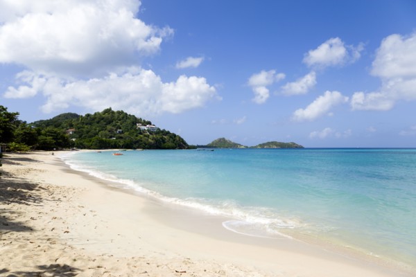 WEST INDIES, Grenada, Carriacou, The calm clear blue water breaking on Paradise Beach in L'Esterre