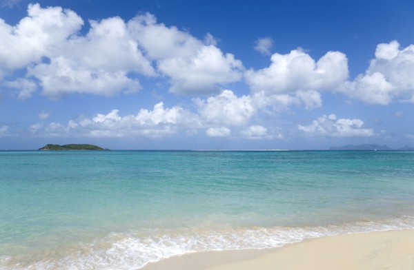 WEST INDIES, Grenada, Carriacou, The calm clear blue water breaking on Paradise Beach in L'Esterre