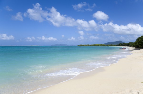 WEST INDIES, Grenada, Carriacou, The calm clear blue water breaking on Paradise Beach in L'Esterre
